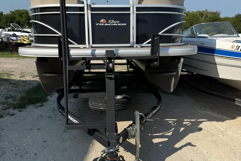 Slide: The Image of 2021 Sun Tracker Party Barge 22 DLX pontoon boat on trailer, front view. - 5