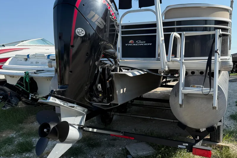 Slide: The Image of 2021 Sun Tracker Party Barge 22 DLX pontoon boat with outboard motor, docked on trailer. - 7