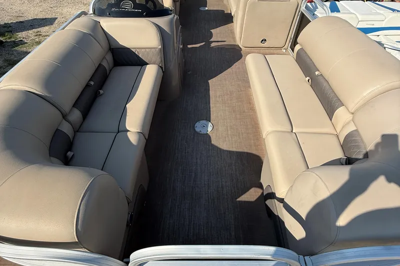 Slide: The Image of 2021 Sun Tracker Party Barge 22 DLX interior with beige seating and spacious layout. - 9