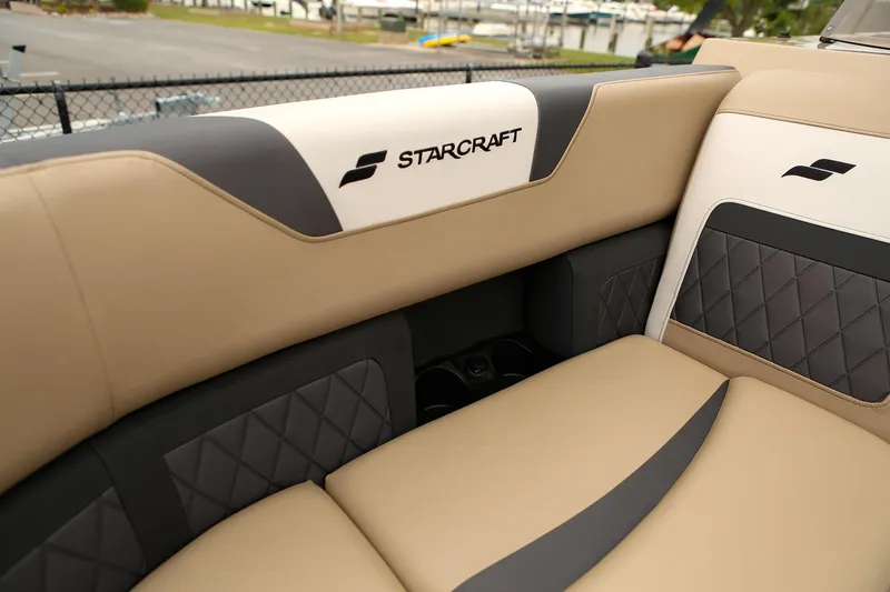 Slide: The Image of 2026 Starcraft SLS 3 boat interior with beige and black quilted seating. - 13