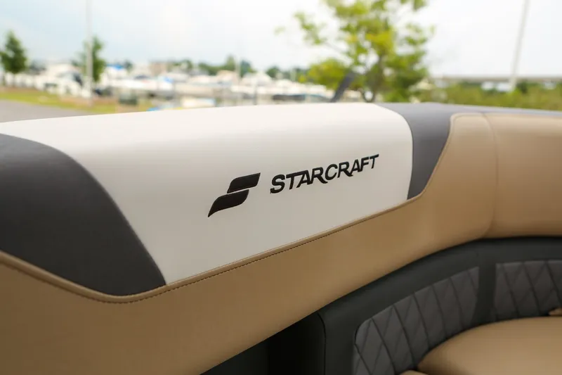 Slide: The Image of 2026 Starcraft SLS 3 boat interior with logo on beige and white seating. - 22