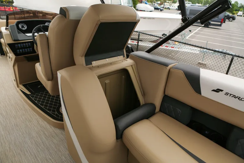 Slide: The Image of Interior of 2026 Starcraft SLS 3 boat with tan seating and storage compartment. - 23