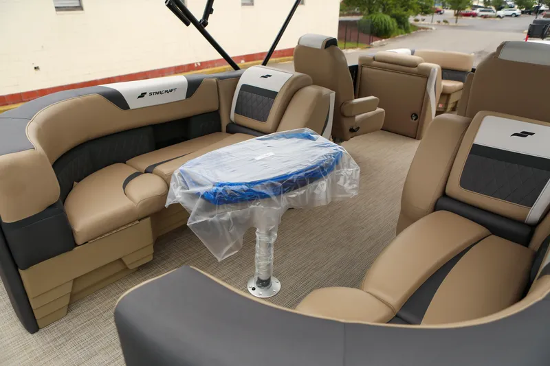 Slide: The Image of Luxurious interior of 2026 Starcraft SLS 3 boat with plush seating and covered table. - 25