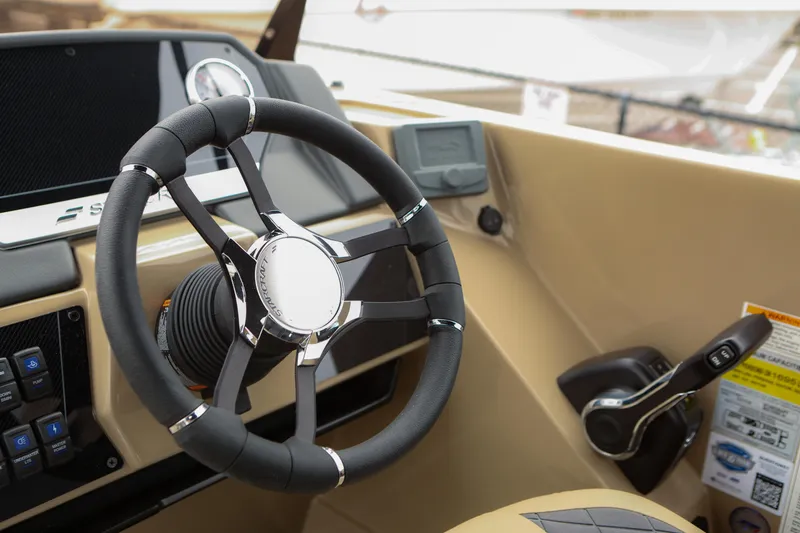 Slide: The Image of Steering wheel of 2026 Starcraft SLS 3 boat, featuring modern controls and dashboard. - 5