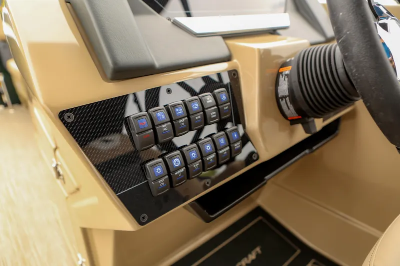 Slide: The Image of Control panel of 2026 Starcraft SLS 3 boat with various switches and steering wheel. - 8