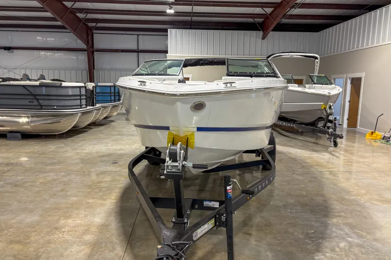 Slide: The Image of 2026 Four Winns H1 boat on trailer in indoor showroom. - 3