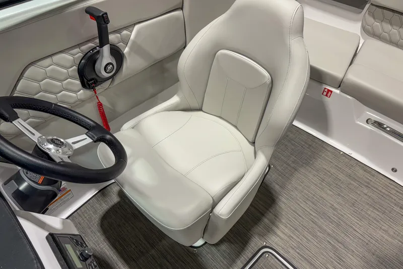 Slide: The Image of 2026 Four Winns H1 boat interior with steering wheel and captain's seat. - 8