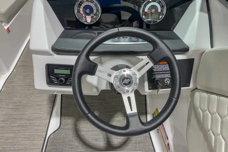 Slide: The Image of Steering wheel and dashboard of 2026 Four Winns H1 boat, featuring modern controls and gauges. - 9