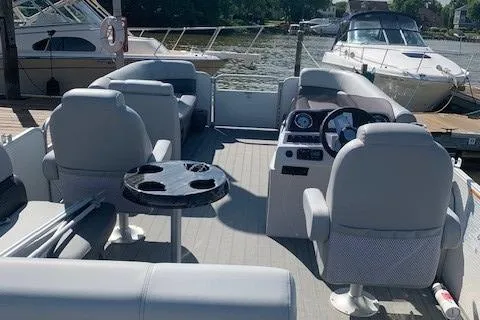 Slide: The Image of 2020 Sweetwater 2286 SFL pontoon boat interior with seating and steering console. - 2