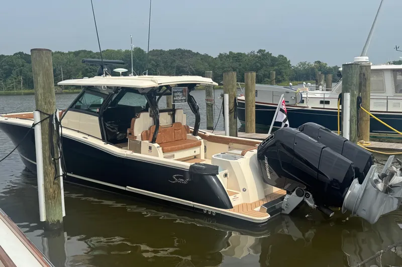 The Image of 2023 Scout 400 LXF boat docked with twin Mercury outboard engines. - 0