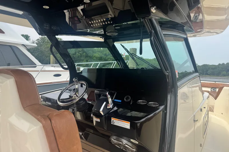 Slide: The Image of 2023 Scout 400 LXF boat interior with modern steering and controls. - 13