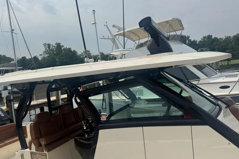 Slide: The Image of 2023 Scout 400 LXF boat with sleek design, docked at marina. - 14