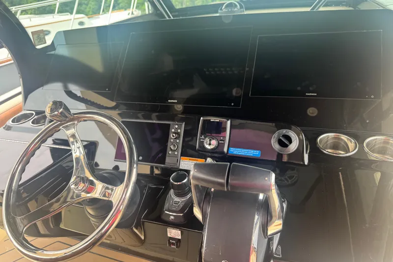 Slide: The Image of 2023 Scout 400 LXF boat dashboard with steering wheel and navigation screens. - 16