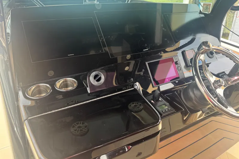 Slide: The Image of 2023 Scout 400 LXF boat dashboard with modern controls and steering wheel. - 17