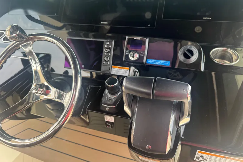 Slide: The Image of 2023 Scout 400 LXF boat dashboard with steering wheel and controls. - 18