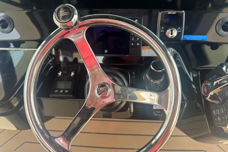 Slide: The Image of Steering wheel and controls of 2023 Scout 400 LXF boat cockpit. - 23