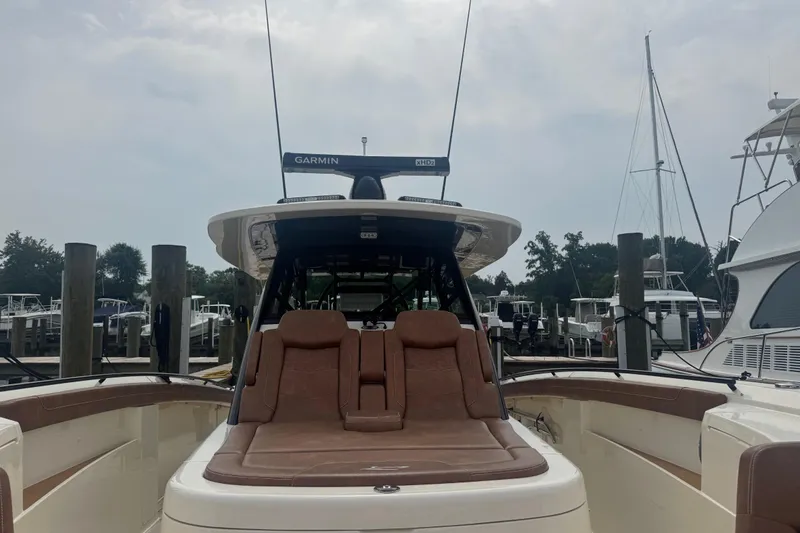 Slide: The Image of 2023 Scout 400 LXF boat with Garmin equipment, docked at a marina. - 24