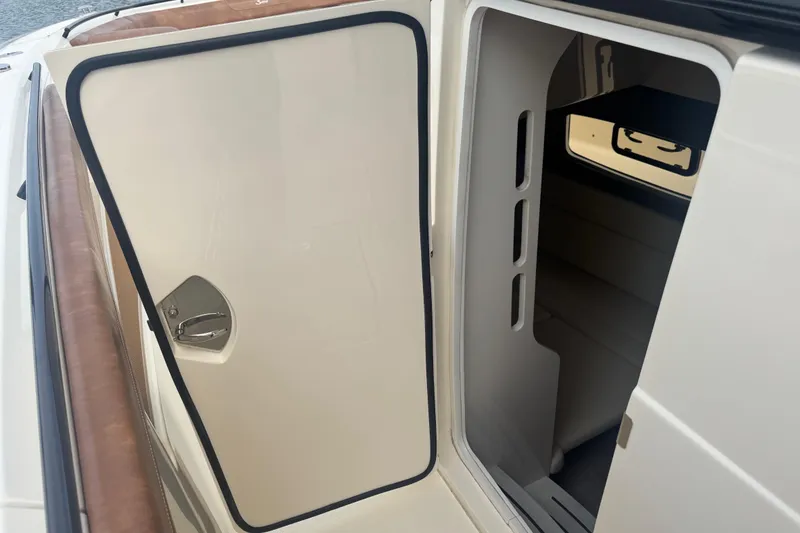 Slide: The Image of 2023 Scout 400 LXF cabin entrance with open door, showcasing interior seating. - 32