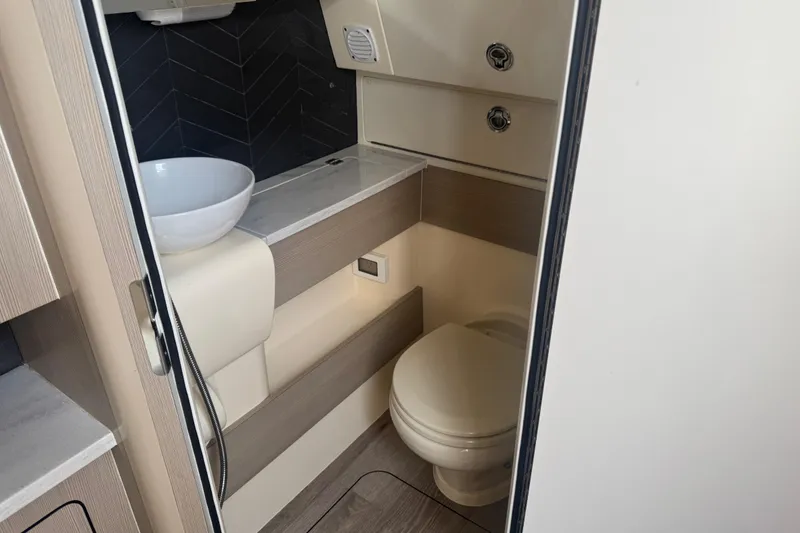 Slide: The Image of 2023 Scout 400 LXF boat bathroom with modern sink and toilet. - 34