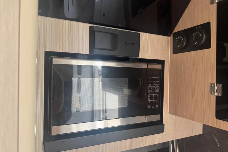 Slide: The Image of Built-in microwave in 2023 Scout 400 LXF boat interior kitchen. - 36