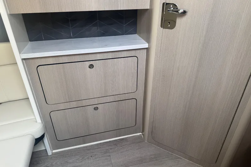 Slide: The Image of Interior of 2023 Scout 400 LXF boat with modern cabinetry and seating. - 38