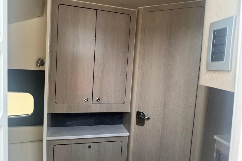 Slide: The Image of 2023 Scout 400 LXF interior with wooden cabinets and modern design. - 39