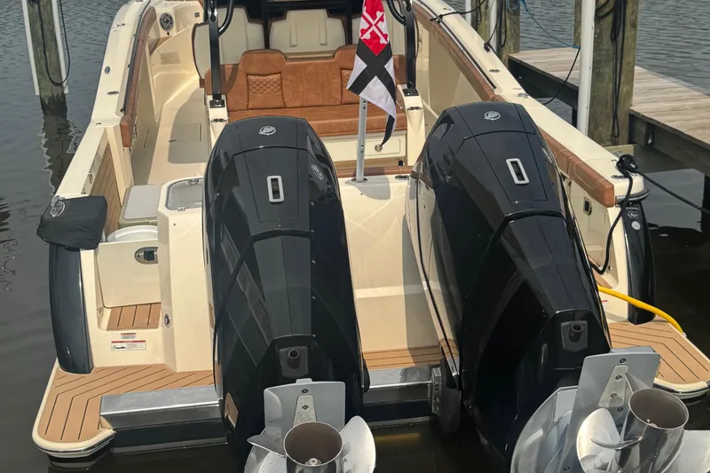Slide: The Image of 2023 Scout 400 LXF boat with dual engines docked at marina. - 4