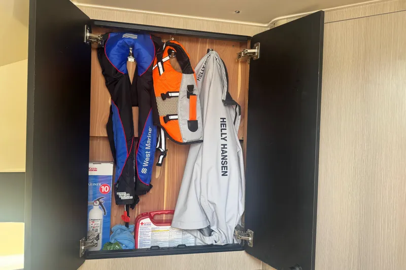 Slide: The Image of Cabinet on 2023 Scout 400 LXF boat with life jackets and safety gear. - 40