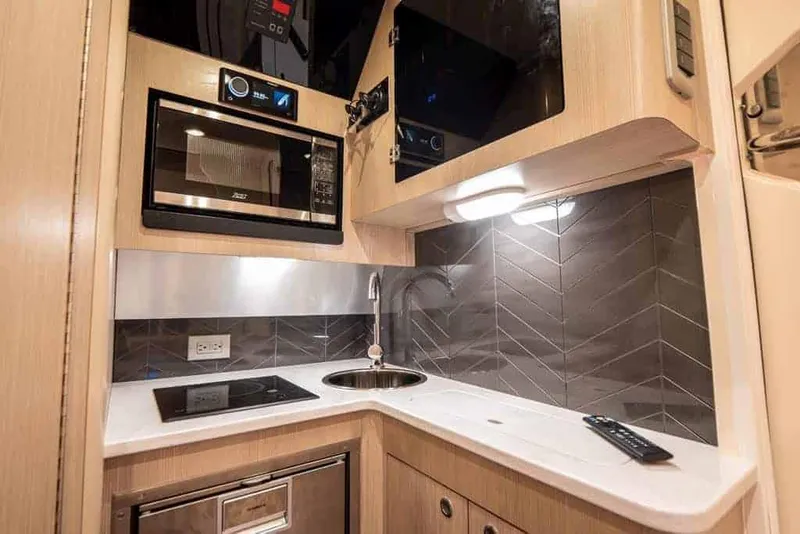 Slide: The Image of Manufacturer Provided Image: 2023 Scout 400 LXF boat kitchen with modern appliances and sleek design. - 42