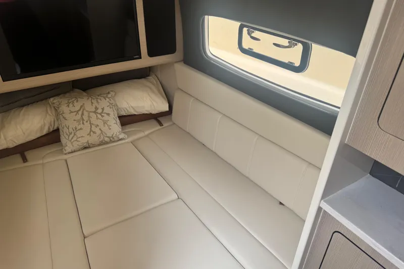 Slide: The Image of 2023 Scout 400 LXF cabin interior with plush seating and window view. - 44