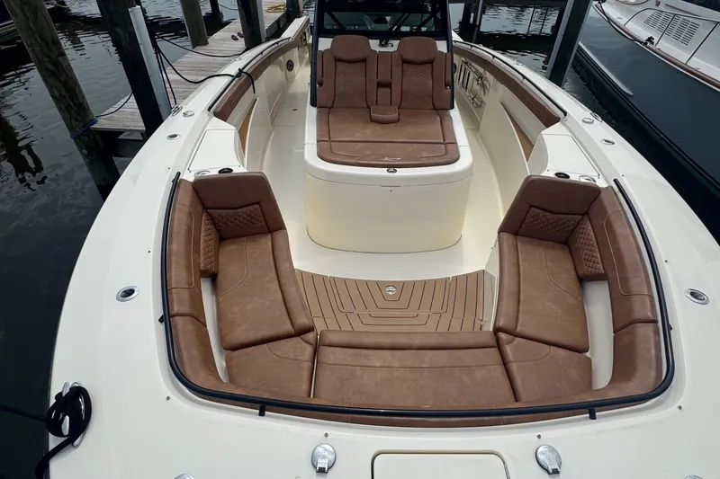 Slide: The Image of 2023 Scout 400 LXF boat with luxurious brown leather seating and spacious deck. - 48