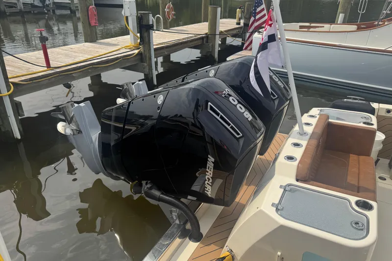 Slide: The Image of 2023 Scout 400 LXF boat with dual Mercury outboard engines docked at marina. - 5