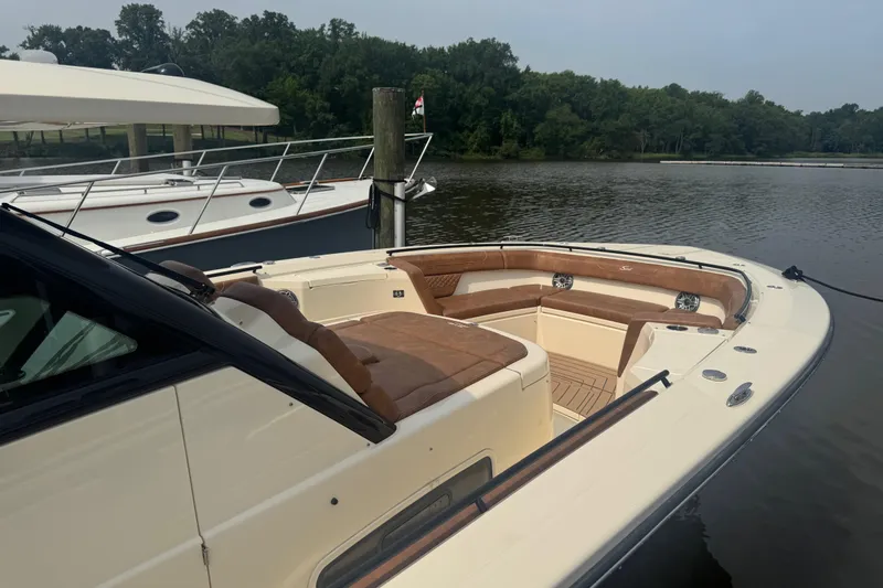 Slide: The Image of 2023 Scout 400 LXF luxury boat docked on a serene lake. - 51