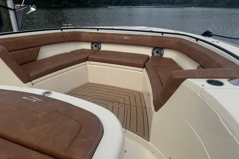 Slide: The Image of Luxurious seating area on 2023 Scout 400 LXF boat with brown leather upholstery. - 52