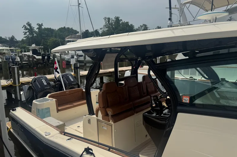 Slide: The Image of 2023 Scout 400 LXF luxury boat docked, featuring sleek design and powerful engines. - 6