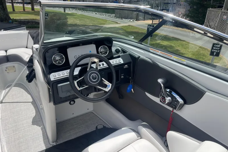 Slide: The Image of 2024 Crownline 240 SS boat interior with modern steering and control panel. - 4