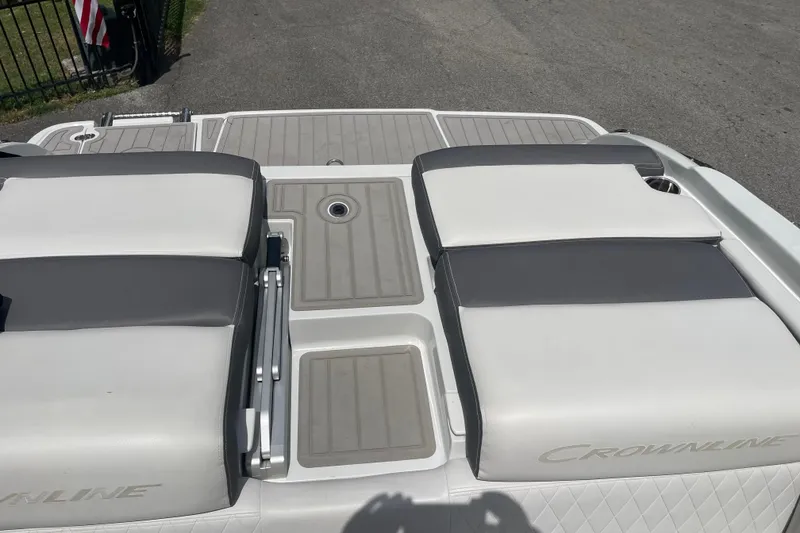 Slide: The Image of 2024 Crownline 240 SS boat deck with cushioned seating and cup holder. - 7