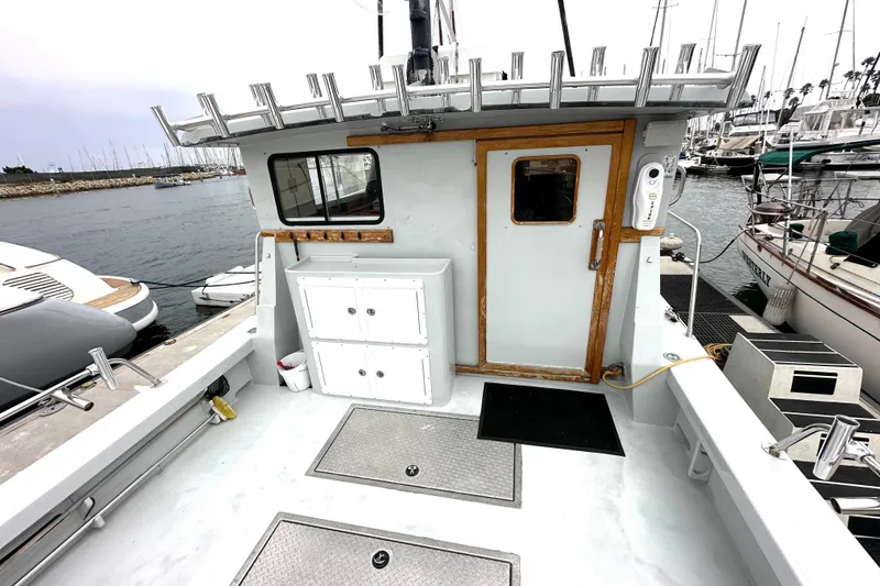 Slide: The Image of Custom NUWAVE 36 boat deck, 1990 model, docked at marina with storage cabinets. - 15