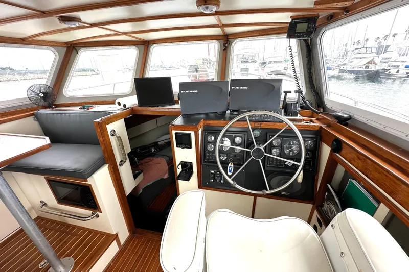 Slide: The Image of Interior of 1990 Custom NUWAVE 36 boat with steering wheel and navigation equipment. - 17