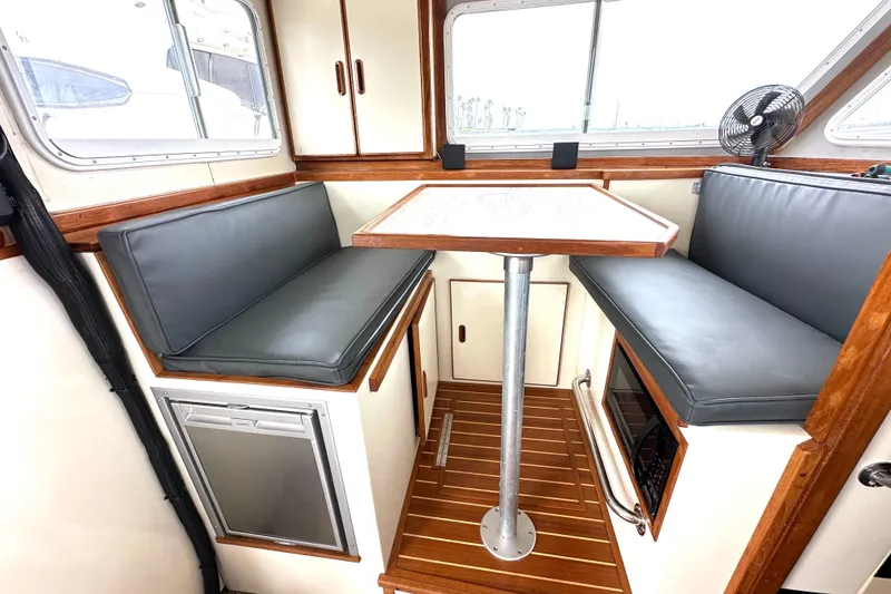 Slide: The Image of Interior of 1990 Custom NUWAVE 36 boat with seating, table, and wood accents. - 22