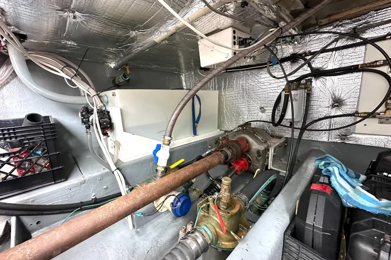 Slide: The Image of Engine room of a 1990 Custom NUWAVE 36 with pipes, wiring, and insulation. - 27