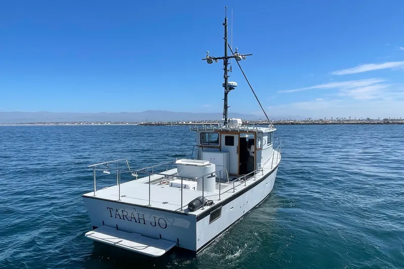 Slide: The Image of Custom NUWAVE 36 boat "Tarah Jo" on open water, clear blue sky, 1990 model. - 4
