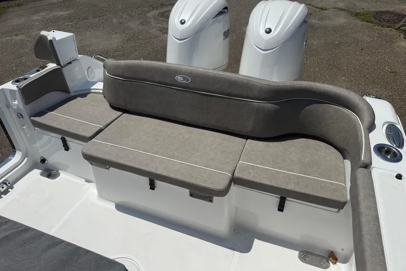 Slide: The Image of 2026 Sea Hunt Ultra 265 SE boat with gray cushioned seating and dual engines. - 13