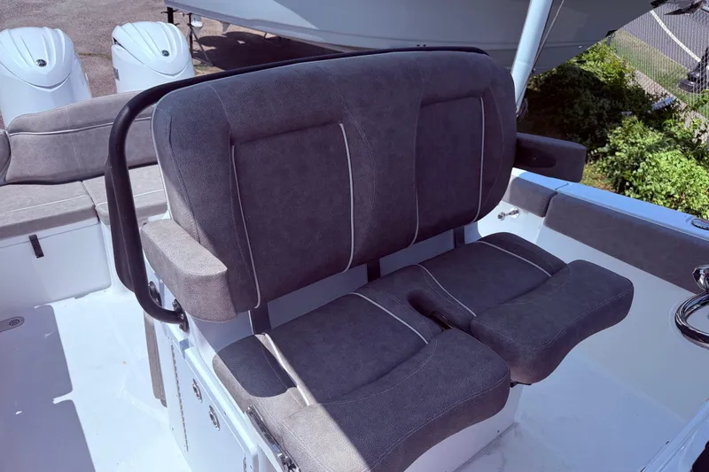 Slide: The Image of 2026 Sea Hunt Ultra 265 SE boat seating with dual outboard engines in background. - 15