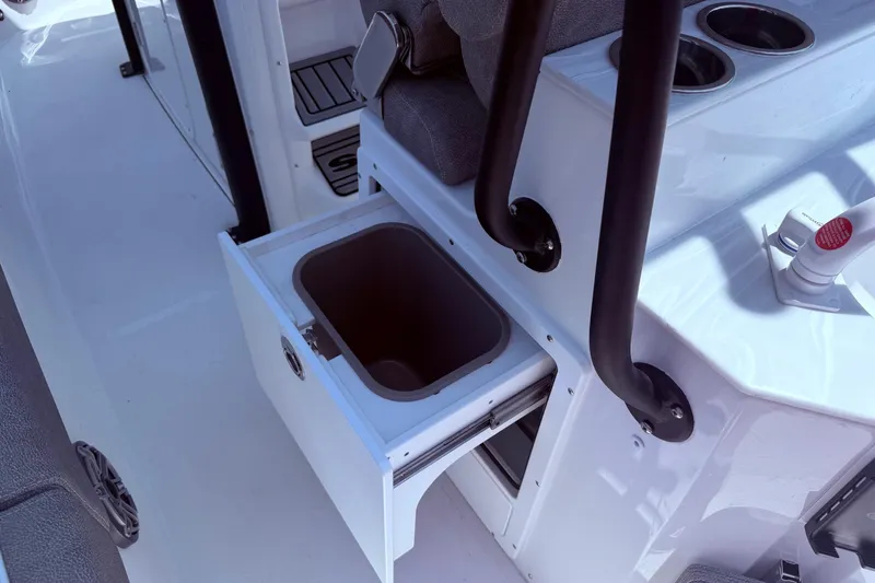Slide: The Image of Interior of 2026 Sea Hunt Ultra 265 SE boat with open storage compartment. - 16