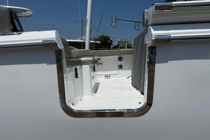 Slide: The Image of 2026 Sea Hunt Ultra 265 SE boat interior with seating and open deck view. - 19