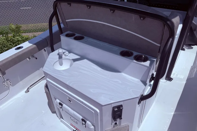 Slide: The Image of 2026 Sea Hunt Ultra 265 SE boat interior with sink and cup holders. - 4