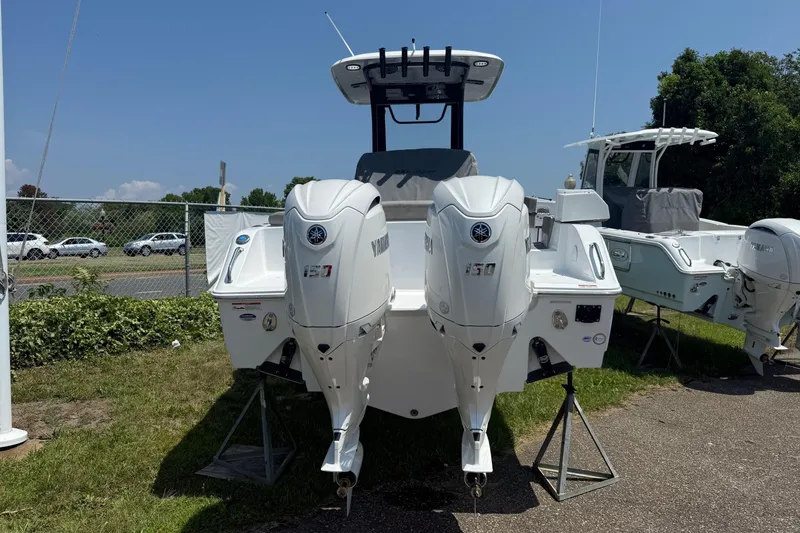 Slide: The Image of 2026 Sea Hunt Ultra 265 SE boat with dual Yamaha engines on display outdoors. - 5