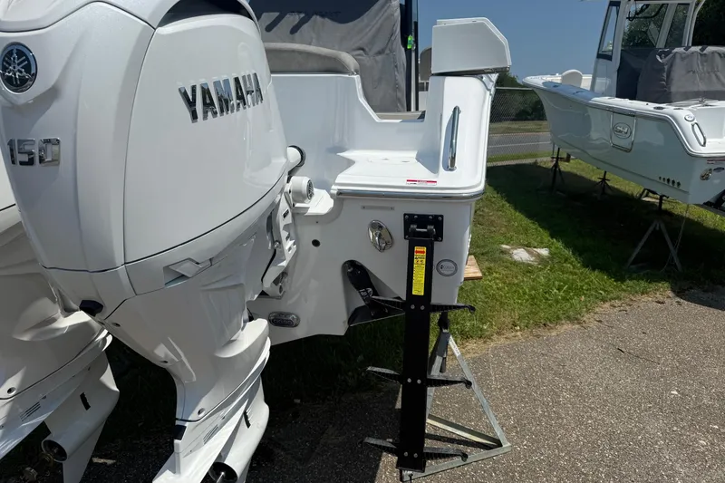 Slide: The Image of 2026 Sea Hunt Ultra 265 SE with Yamaha 150 engine, displayed outdoors. - 6