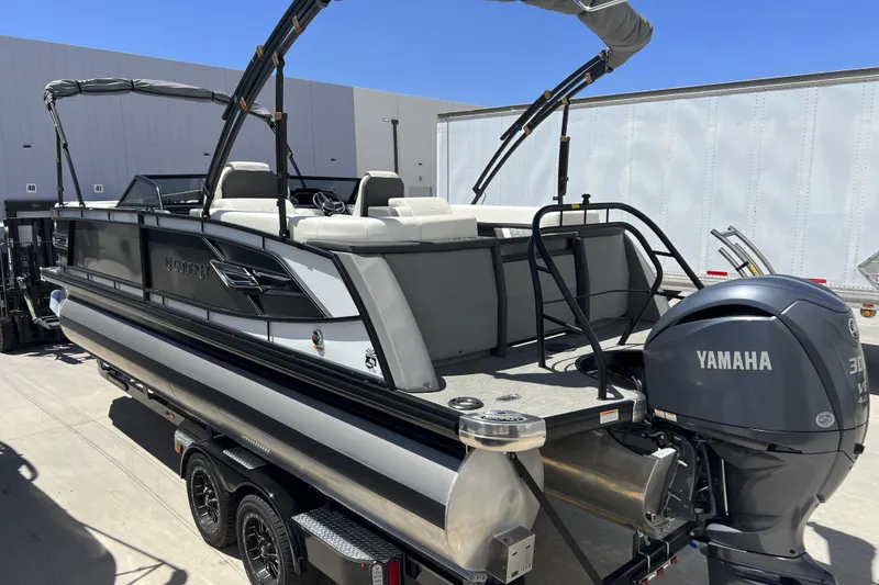 Slide: The Image of 2022 Godfrey AquaPatio 255 SBW pontoon boat with Yamaha 300 engine, parked outdoors. - 12